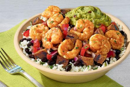QDOBA Citrus Lime Shrimp bowl with sautéed shrimp, cilantro-lime rice, black beans, pico de gallo, and fresh guacamole
