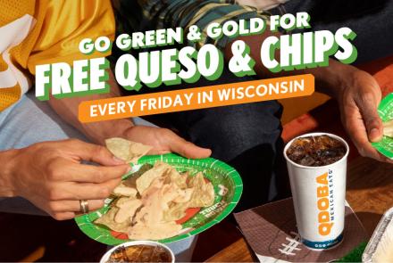 Close-up of hands holding plates of tortilla chips topped with queso, with one person in a gold jersey and another in a green shirt, highlighting QDOBA’s Green & Gold Friday free queso and chips promotion in Wisconsin.